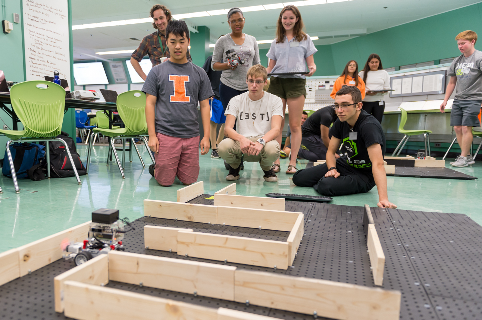 High schoolers monitor their robot’s progress in the second maze on the final afternoon of camp.