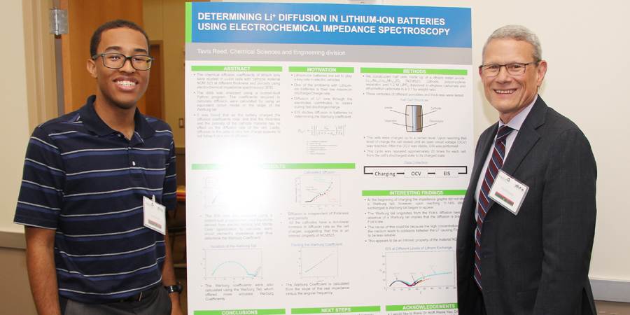 Tavis Reed presents his research about lithium-ion batteries to Argonne Interim Laboratory Director Paul Kearns. 