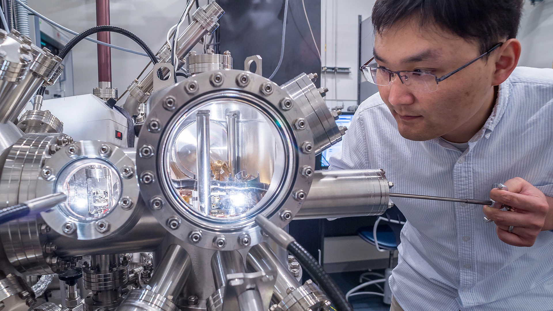 Postdoctoral researcher Rui Zhang at the Center for Nanoscale Materials uses an ultrahigh vacuum scanning tunneling microscope to image the surface structure of nanomaterials.