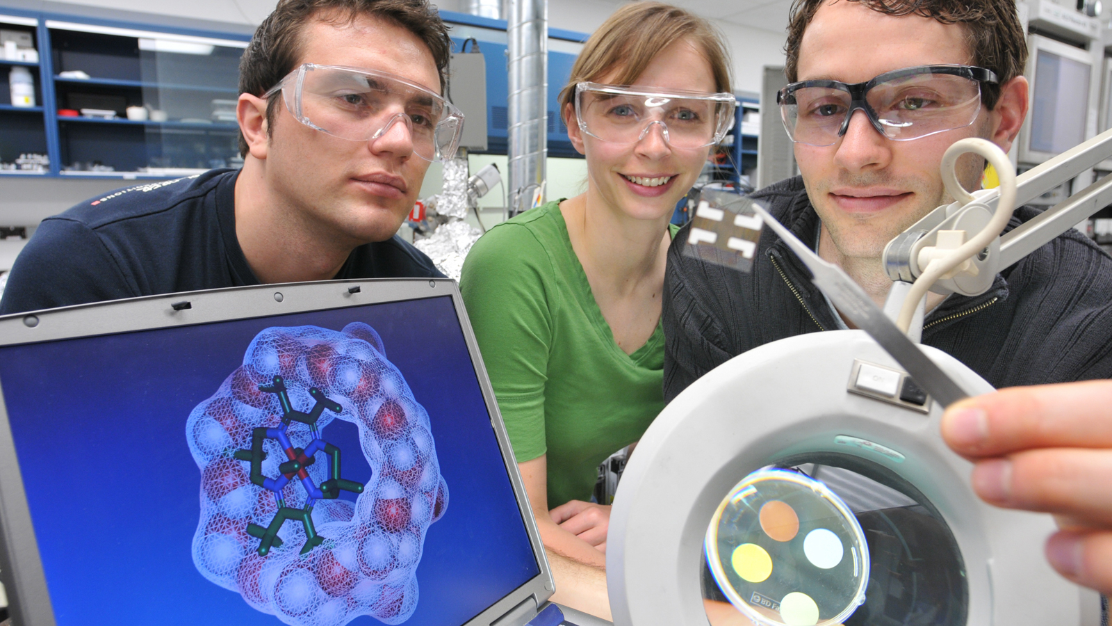 Postdoctoral students Ioan Botiz (left), Karen Mulfort and Alex Martinson are exploring the possibility of coupling photovoltaic devices (magnifier) and solar fuel (monitor).