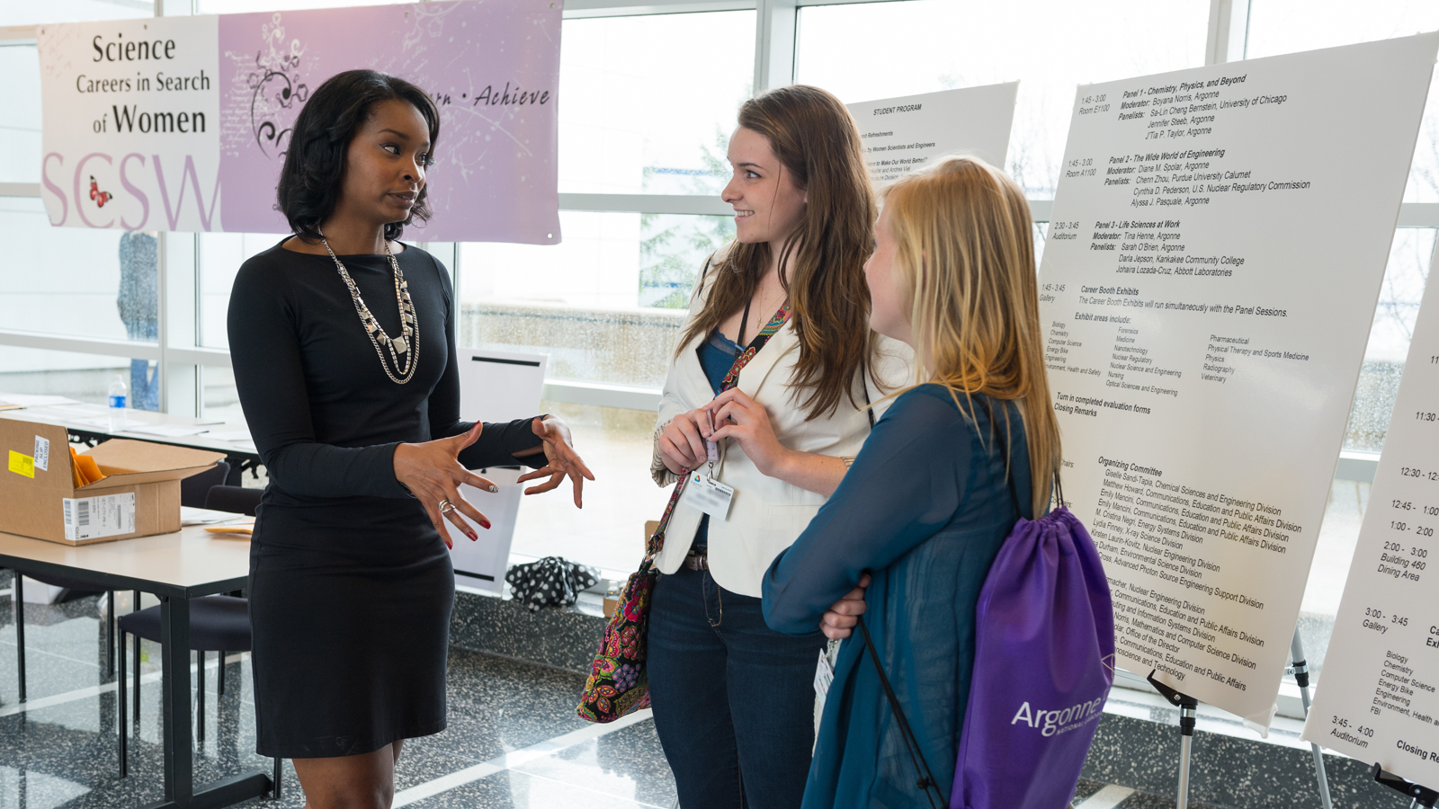 J'Tia Taylor (left), a nonproliferation technical specialist in Argonne’s Nuclear Engineering Division, speaks with event attendees. 