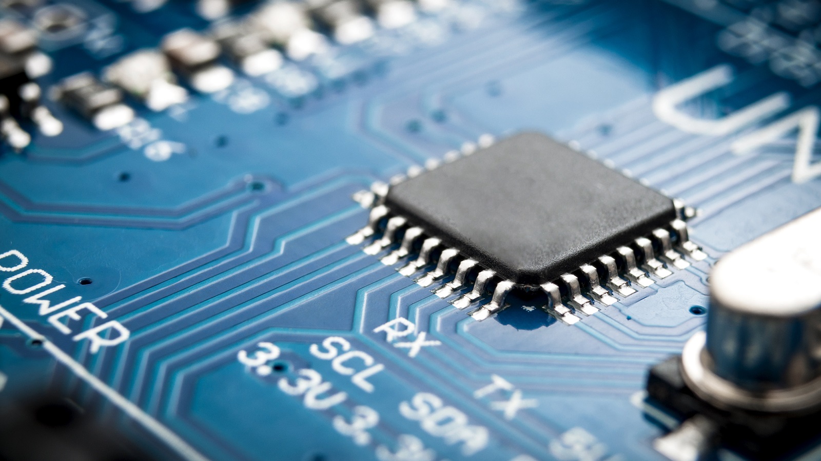 Integrated semiconductor microchip microprocessor on blue. (Image by Victor Moussa/Shutterstock.)