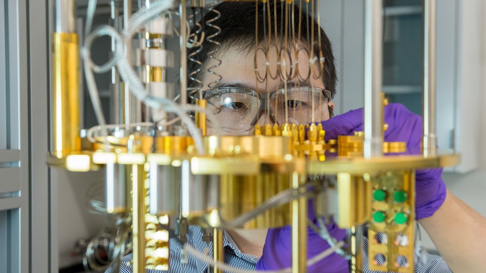 Argonne scientist Dafei Jin observes a dilution refrigerator, a cryogenic cooling device for materials used for quantum computing