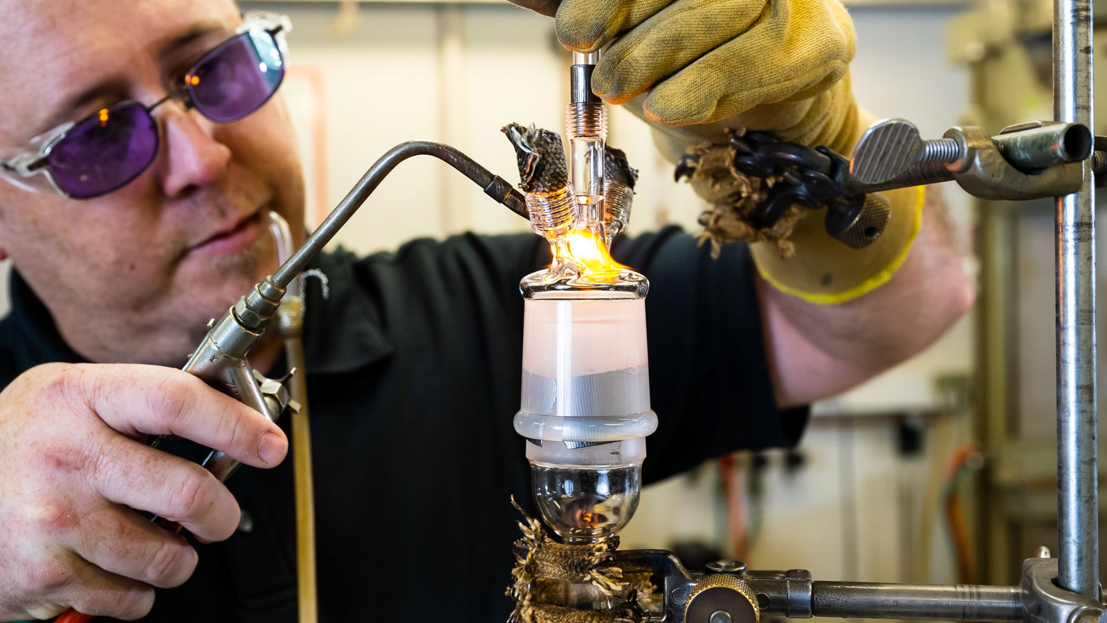 Man applying flame to glass item. (Image by Argonne National Laboratory.)