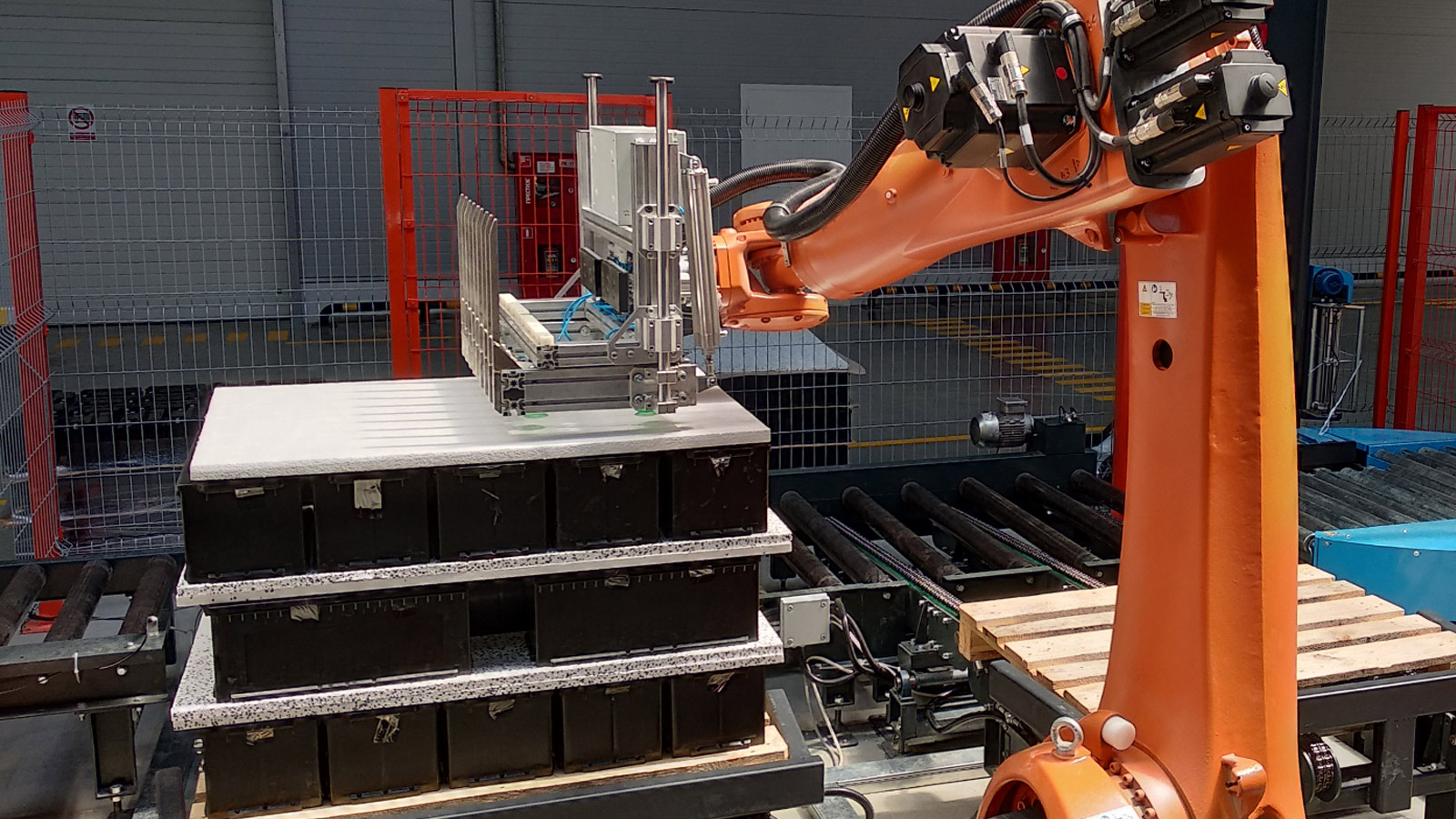 A robot palletizes lithium-ion batteries during production.