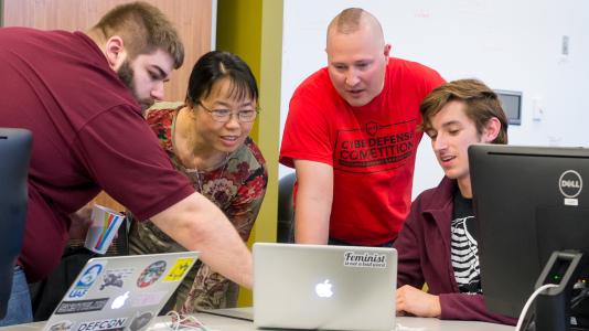 Members of the Red Team strategize new ways to attack the systems of teams at the first annual Argonne Collegiate Cyber Defense Competition