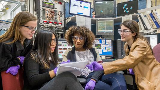 Neuqua Valley High School students Anna Thomas, Vanessa Cai, Nadia Young and Natalie Ferguson discuss an experiment at Sector 20 of the Advanced Photon Source.