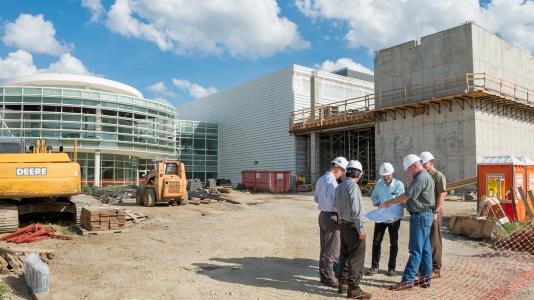 Building project managers and scientific leads confer at the site of a new clean room under construction at Argonne National Laboratory.