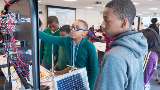 At “Charging up the Classroom,” students check how much power they have produced after using wind turbines and solar panels to generate electricity. All photos by Mark Lopez/Argonne National Laboratory. 