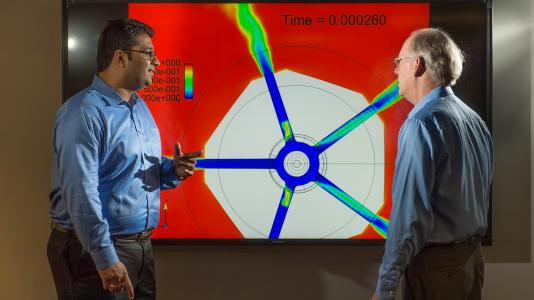 Sibendu Som (left) and computational scientist Raymond Bair discuss combustion engine simulations conducted on Argonne’s Mira supercomputer, with the aim of gaining further insight into the inner workings of combustion engines. 