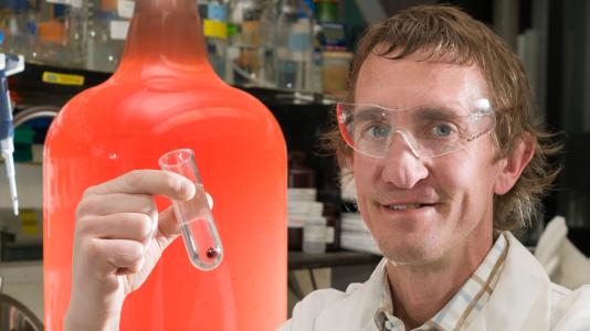 Argonne bioscientist Phil Laible displays a sample of a photosynthetic bacterium capable of creating usable biofuels from wastewater streams.