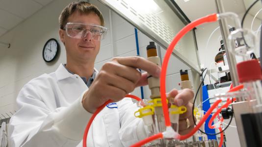 Argonne chemist Trevor Dzwiniel sets up a reaction calorimeter at the Materials Engineering Research Facility, which is designed specifically to help get lab breakthroughs more quickly to shelves.