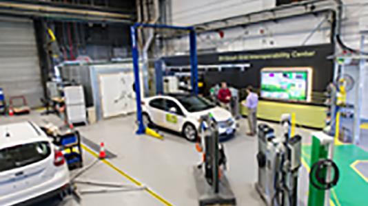 Engineers Jason Harper (left) and Daniel Dobrzynski at work in Argonne’s Electric Vehicle Interoperability Center, which seeks to create worldwide standards for electric car plugs and charging stations.