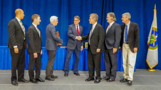 U.S. Secretary of Energy Rick Perry congratulates members of the Scientific and Operational Leadership team for the Joint Center for Energy Storage Research (JCESR) on the award.