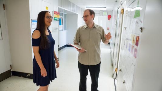 Argonne intern Savanna Dautle and chemist David Bross discuss research to develop more reliable computer models for gaseous systems. (Image by Argonne National Laboratory.)