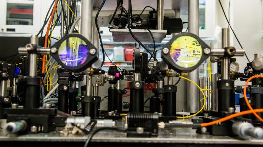 Argonne senior scientist David Awschalom is collaborating with the University of Chicago and Fermilab on an ambitious project to link the two U.S. national laboratories. Awschalom is shown in reflection on the right in his lab at the University.