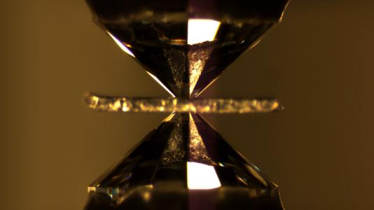 Argonne scientists have identified another material that can produce both magnetism and superconductivity: ytterbium. This shows the diamond anvil cell used to generate the required pressures to uncover this property.