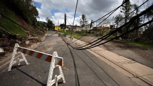 Barricade blocking road that has powerlines down. (Image by Shutterstock / RaiPhoto.) 