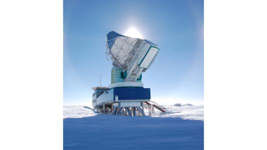 Large telescope against blue sky and ice landscape. (Image by Argonne National Laboratory.)