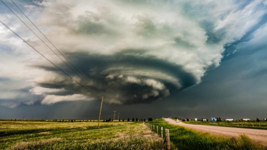 Dark cloud bank circulating over a field. (Image by  Shutterstock/Cammie Czuchnicki.)