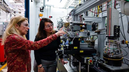 Maria Kokkori, left, formerly of the Art Institute of Chicago and Patti Gibbons of UChicago with the "Concrete Book" at Beamline 6-BM of the Advanced Photon Source. (Image by Jason Creps/Argonne National Laboratory.)