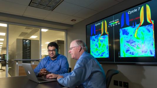 Argonne mechanical engineer Sibendu Som and computational scientist Raymond Bair discuss combustion engine simulations conducted by researchers using the CONVERGE code at the Virtual Engine Research Institute and Fuels Initiative (VERIFI).
