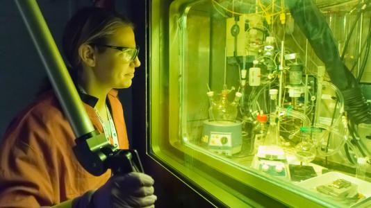 Chemist Amanda Youker operates a remote manipulator arm in a radiation-shielded cell. The cell is used for the purification of molybdenum-99 in a process recently demonstrated by Argonne that could lead to a domestic source of the important medical isotope. (Photo by Wes Agresta.)