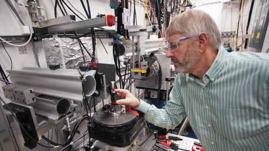 Prof. Stuart Stock (Northwestern University) in the X-ray Science Division beamline 2-BM research station at the Advanced Photon Source (APS), readying a sample of shark spine for imaging using the high-brightness X-rays from the APS. (Image by Argonne National Laboratory.)