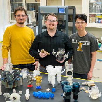 The laboratory’s new 3D printing methods makes make its recycling method – pioneered in 2015 by Mo-99 program manager Peter Tkac (left) and others – faster, more reliable, and more cost effective. Also shown: Peter Kozak (center) and Brian Saboriendo. Not shown: Alex Brown. (Image by Argonne National Laboratory.)